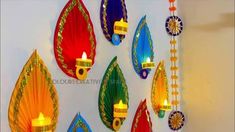 colorful paper umbrellas are hung on the wall with candles in them and hanging from strings