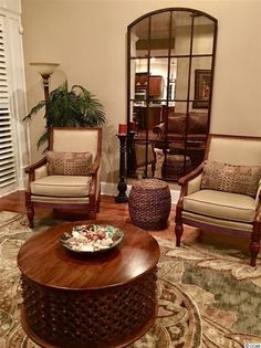 a living room filled with furniture and a mirror