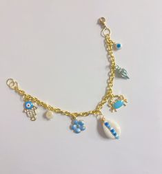 Blue Beach Vibe Charm Bracelet 7 charms Beach Charms Bracelet Jewelry, Gold Charm Bracelet With Lobster Clasp For Beach, Blue Charm Bracelet Jewelry, Blue Dangle Bracelets With Charms, Blue Jewelry With Dangling Charms, Vacation Bracelet With Starfish Charm, Handmade Dangle Bracelets For Beach, Gold Bracelets With Lobster Clasp For Vacation, Gold Bracelet With Lobster Clasp For Vacation