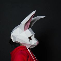 a person wearing a paper bunny mask and red hoodie with the face of a white rabbit