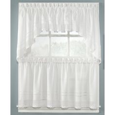 a white kitchen curtain with ruffles and scalloped edges in front of a window