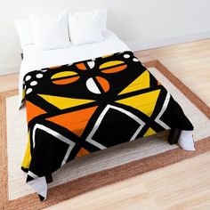 a bed with an orange and black design on it