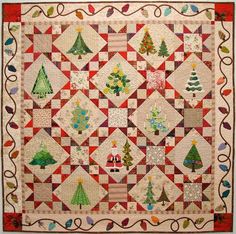 a quilt with christmas trees on it is shown in red, white and green colors