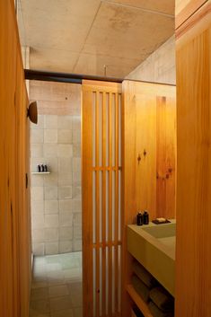 a bathroom with wooden walls and tiled flooring