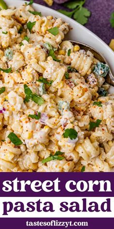 a bowl filled with pasta salad on top of a table