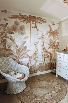 a white dresser sitting next to a wall with a giraffe mural on it