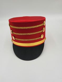 The Nicky Bigs Novelties™ ADULT TOY SOLDIER HAT Become the Toy Soldier, or the Band Leader in the Parade! Select from a Blue, Black, or Red hat featuring gold accents. Each hat is comfortable and lightweight. Great for Halloween, Cosplay, Theater and more! Perfect accessory for Nutcracker, Conductor, Toy Soldier, Band Leader and more! Hat stands approximately 5" tall and fits approximately 58 cm, 7-1/4 American 7-3/8 European. ⭐ Adult Toy Soldier Hat. Select from Blue/Red, Red/Black, and Black. ⭐Each hat features gold trim strips and button accent.  Perfect for Men, Women, and Teens! ⭐Lightweight and comfortable to wear! Each cosplay hat stands approximately 5" tall. ⭐Sized approximately 58 cm or 22.8 inches in circumference.  ⭐Each hat is made of Polyester fabric with a Cardboard frame fo Red Themed Costume Accessories For Gifts, Red Themed Costume Accessories For Gift, Themed Red Costume Accessories For Gift, Themed Red Costume Accessories As Gift, Red Themed Adjustable Costume Accessories, Adjustable Christmas Costume Party Accessories, Adjustable Red Hat For Costume Party, Red Adjustable Hat For Costume Party, Red Christmas Costume Accessories