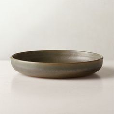 a gray bowl sitting on top of a white table