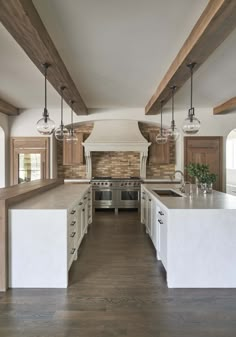 a kitchen with an island, stove and oven in it's center area is shown