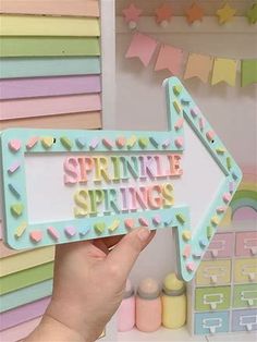 someone holding up a sign that says springtime springs on it in front of some crafting supplies