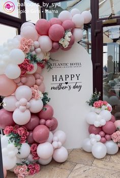 the entrance to atlantic hotel is decorated with pink, white and pink balloons that spell out happy mother's day