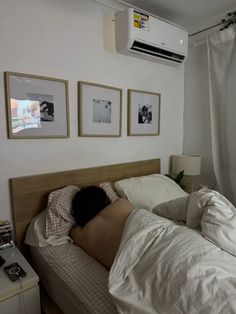 a person laying in bed with their head on the pillow