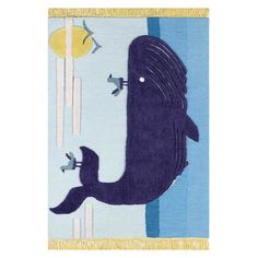 a blue rug with an image of a whale on it