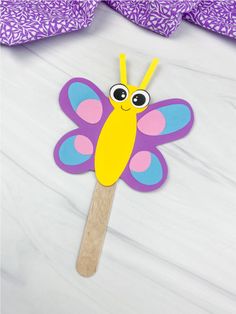 a paper butterfly on a wooden stick