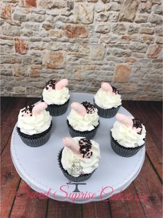 cupcakes with white frosting and chocolate sprinkles on a plate