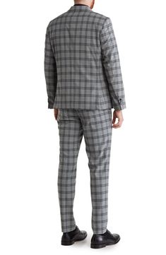 Update your officewear wardrobe with this peaked-lapel suit patterned with a bold plaid print. Blazer has 31" length (size 40R); pants have 32" inseam; 13" front rise (size 34W) Blazer has peaked lapels; four buttons on each cuff; two-button closure; chest welt pocket; front flap pockets Pants have zip fly with hook-and-bar closure; front slant pockets; back welt pockets Lined 69% polyester, 29% rayon, 2% spandex Dry clean Imported Model stats: 6'0" height; 32" waist. Model is wearing size 40R. Tailored Houndstooth Suits For Work, Business Casual Suits With Houndstooth Pattern And Notch Lapel, Business Casual Houndstooth Suit With Notch Lapel, Business Casual Notch Lapel Suits With Houndstooth Pattern, Plaid Single Breasted Suits For Business Casual, Classic Plaid Suits For Workwear, Tailored Plaid Suits For Business Casual, Plaid Notch Lapel Suit For Business Casual, Plaid Suit With Suit Collar For Work