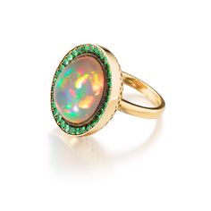 Material: 18k yellow gold

Stone Type/Carat Weight: Opal 10.33cts, Tsavorites 1.58cts

Dimensions: 0.86”L  - 0.73” W Luxury Green Multi-stone Opal Ring, Luxury Tsavorite Emerald Ring, Green Luxury Opal Ring For Formal Occasions, Luxury Yellow Gold Tsavorite Rings, Yellow Gold Tsavorite Ring, South Fashion, Tsavorite Ring, Swords Medieval, How To Look Rich