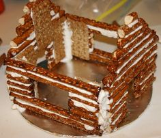 a close up of a cake made to look like a gingerbread house on a plate