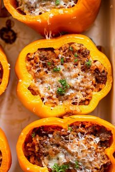 stuffed bell peppers with meat and cheese in a baking dish, ready to be eaten