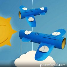 two paper airplanes are flying in the sky next to a sun with strings hanging from it