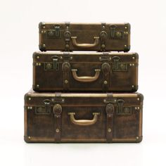 three brown suitcases stacked on top of each other