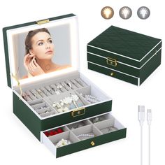 an open green box with jewelry in it and two ear plugs on the side