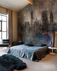 a bedroom with a large painting on the wall