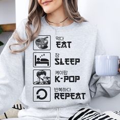 This Eat Sleep Kpop Repeat sweatshirt is a must-have for any Kpop fan. With a funny K Pop design, this shirt is the perfect gift for a Korean music loving teenage girl. It's great for lounging at home or as a casual outfit. Ideal for fans of South Korea, Army members, and anyone obsessed with Kpop. Perfect for birthdays, holidays, or as a fun everyday tee. The shirts have a soft and light feel and are comfortable and flattering for everybody. ----------------------------------------------------- Kpop Clothing, Merch Kpop, Kpop Shirts, Shirt Korean, Affinity Designer, Pop Design, Korean Music, Funny Sweatshirts, Music Lover