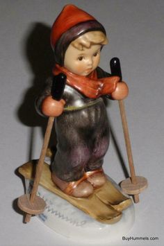 a figurine of a boy on a sled