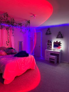 a bedroom with pink and purple lighting on the walls