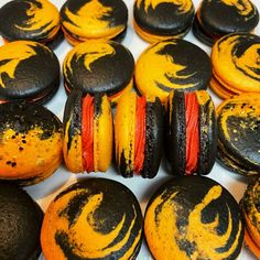 some black and yellow macaroons are sitting on a table