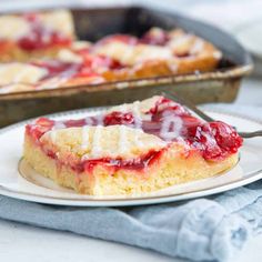 a piece of strawberry shortcake on a plate with a fork next to the pie