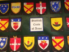 many coats of arms are on display in this museum case with the name scottish coat of arms painted on them