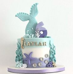 there is a cake decorated with blue and purple sea animals on it's side