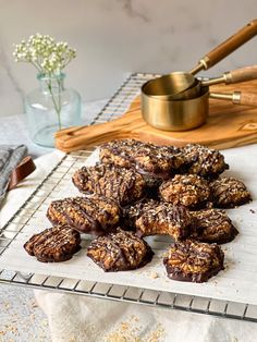 chocolate covered cookies sitting on top of a cooling rack