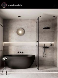 a black bath tub sitting in the middle of a bathroom