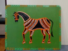 a painted horse on a green background with an orange and black design in the center