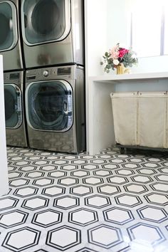 a washer and dryer in a laundry room with black and white flooring