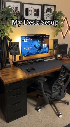 a desk with a monitor and speakers on it