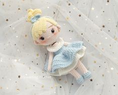 a crocheted doll laying on top of a plastic sheet with stars around it