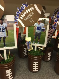 football themed decorations are displayed in buckets