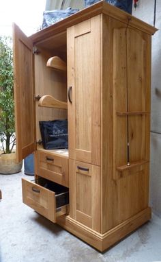 a wooden armoire with drawers in a room