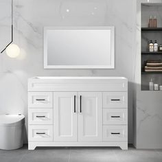 a white bathroom vanity with a mirror above it