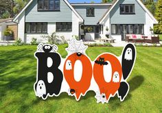 halloween yard decorations in the shape of boos and ghost's on a lawn