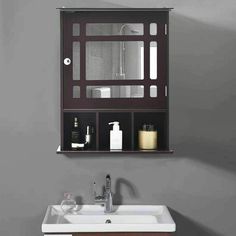 a bathroom sink sitting under a mirror next to a wall mounted cabinet with shelves above it