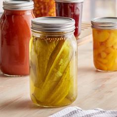 pickles in jars on a wooden table