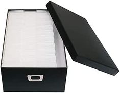 an open black box with white paper inside