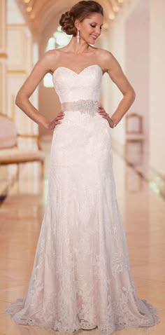 a woman in a white wedding dress standing on a tile floor