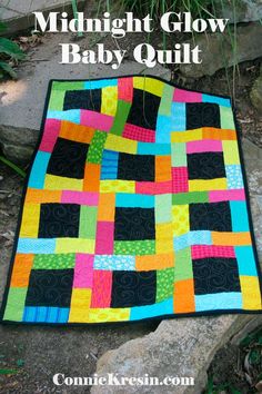 the midnight glow quilt is on display in front of some rocks