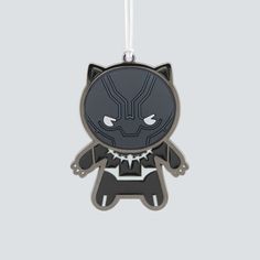 a black cat ornament hanging on a white background with an image of the character